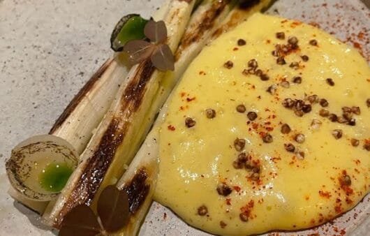 Charred Leeks with Creamy Polenta and Peppercorn Dust