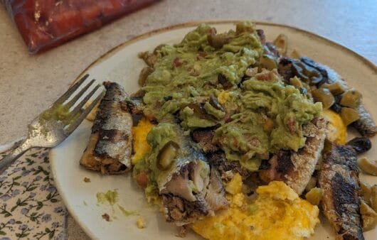 Grilled Sardines on Scrambled Eggs with Guacamole & Olives