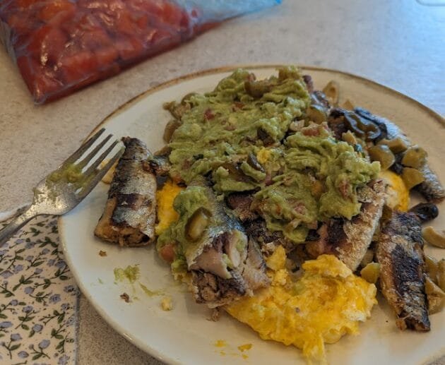 Grilled Sardines on Scrambled Eggs with Guacamole & Olives