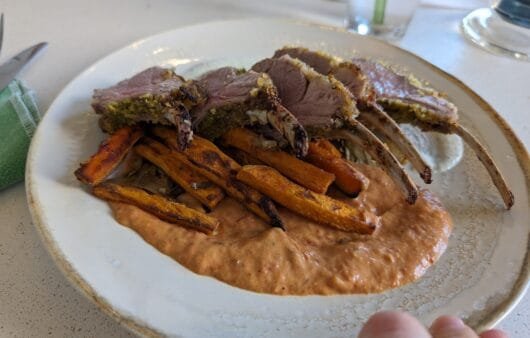 Herb-Crusted Rack of Lamb with Roasted Carrot Fries & Smoky Red Pepper Sauce