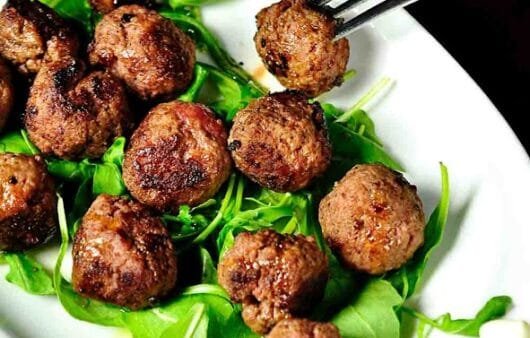 Juicy Herb-Infused Meatballs on Arugula
